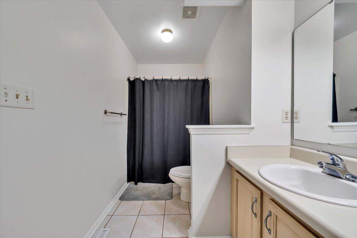 7851 Cedar Edge Road Roanoke, VA 24018 - Photo 22 of 44 a bathroom with a sink a toilet a mirror and vanity