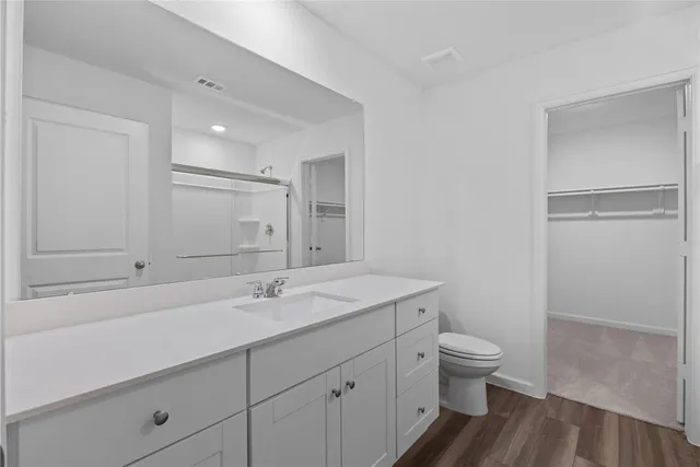 a view of a hallway with wooden floor and entryway
