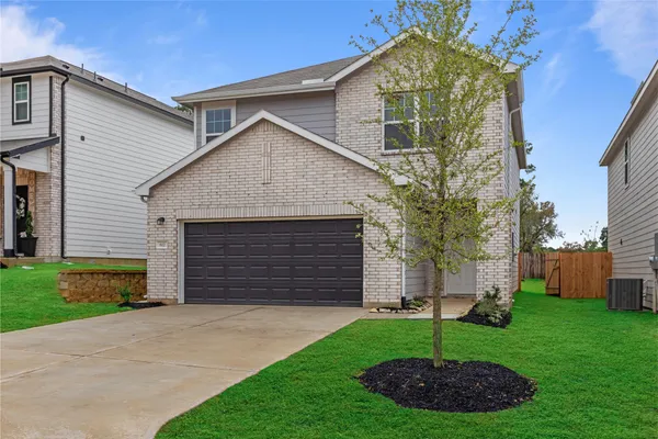 a front view of a house with a yard