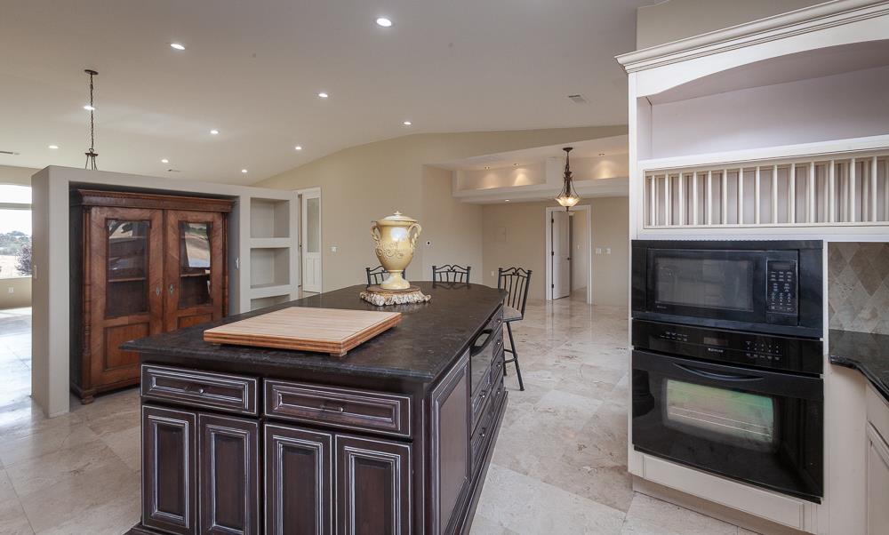 21190 East Acampo Road Clements, CA 95227 - Photo 22 of 89 a kitchen with kitchen island granite countertop a stove and a sink