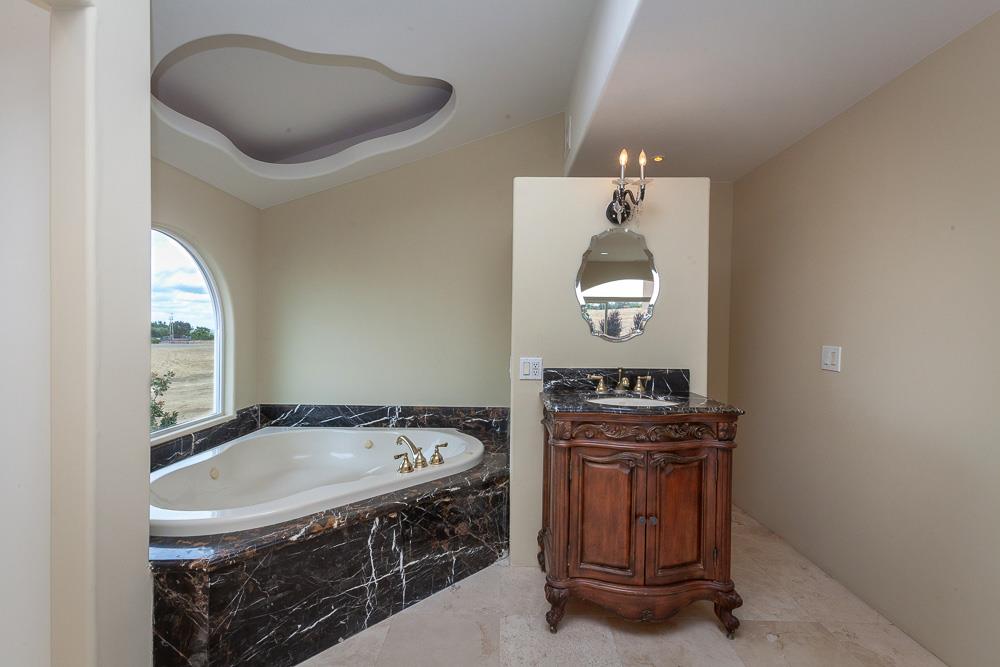 21190 East Acampo Road Clements, CA 95227 - Photo 29 of 89 a bathroom with a sink a mirror and a bathtub