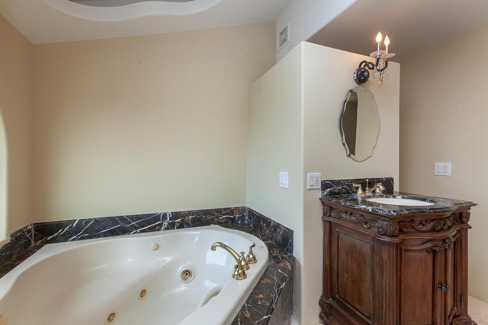 21190 East Acampo Road Clements, CA 95227 - Photo 30 of 89 a bathroom with a granite countertop sink and a mirror