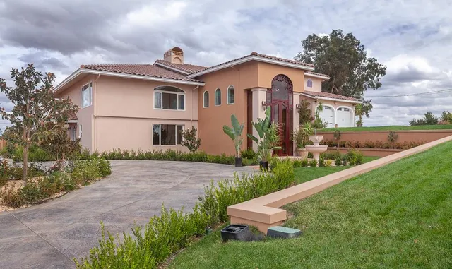 a front view of house with yard and green space