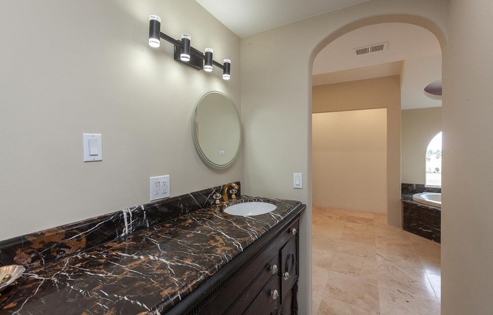 21190 East Acampo Road Clements, CA 95227 - Photo 33 of 89 a bathroom with a granite countertop sink a mirror and vanity