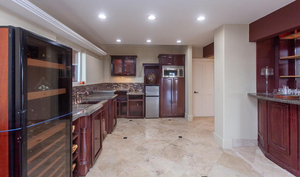 21190 East Acampo Road Clements, CA 95227 - Photo 41 of 89 a kitchen with stainless steel appliances granite countertop a refrigerator and a stove top oven