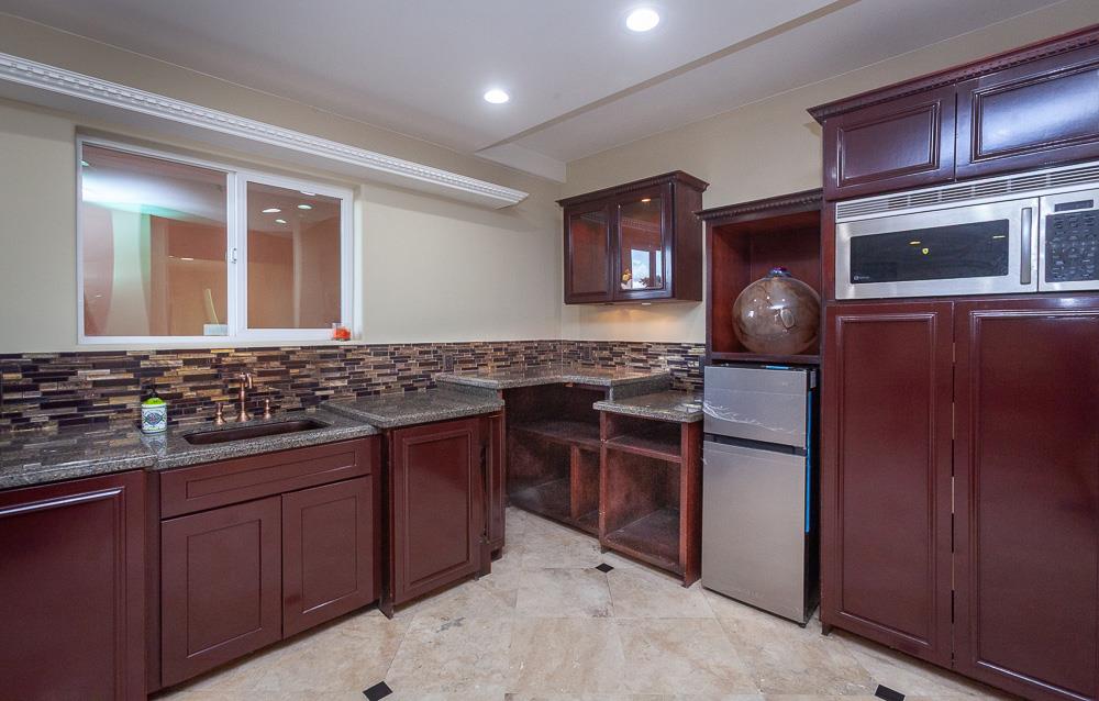 21190 East Acampo Road Clements, CA 95227 - Photo 44 of 89 a kitchen with stainless steel appliances granite countertop a stove and a microwave