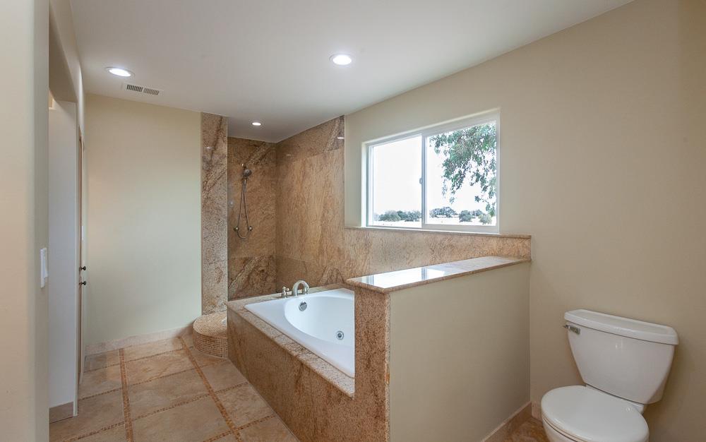 21190 East Acampo Road Clements, CA 95227 - Photo 66 of 89 a bathroom with a granite countertop sink a toilet and bathtub