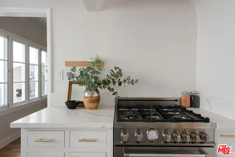 a kitchen with a stove and cabinets