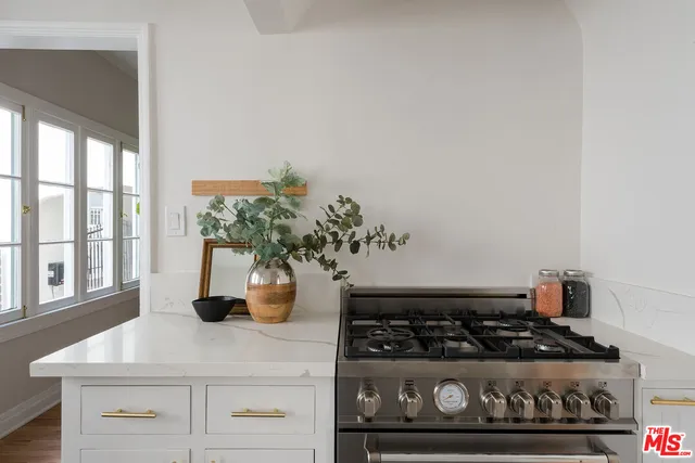 a kitchen with a stove and cabinets