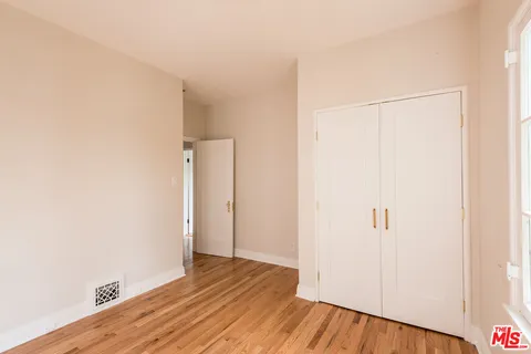 a view of a room with wooden floor