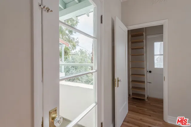 a view of an entryway with wooden floor