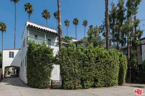 view of a house with potted plants
