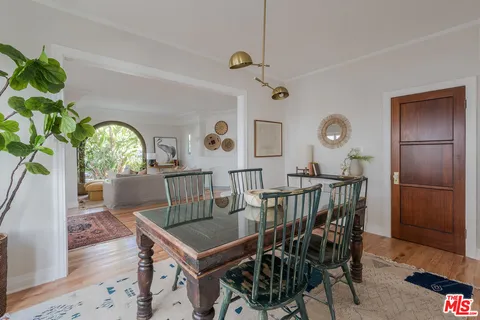 a view of a dining room filled with furniture and window