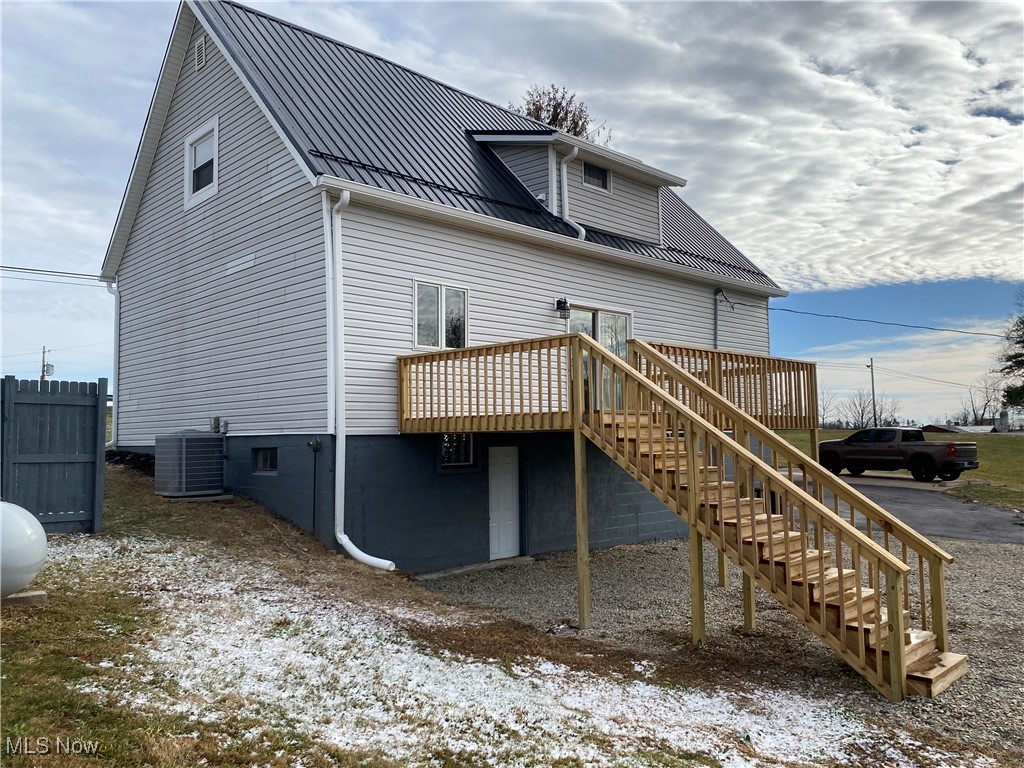 71056 Morristown Flushing Road Flushing, OH 43977 - Photo 3 of 15 Back of house featuring stairway, a deck, and a metal roof