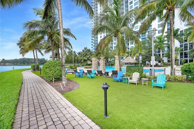 a view of a swimming pool with outdoor seating and plants