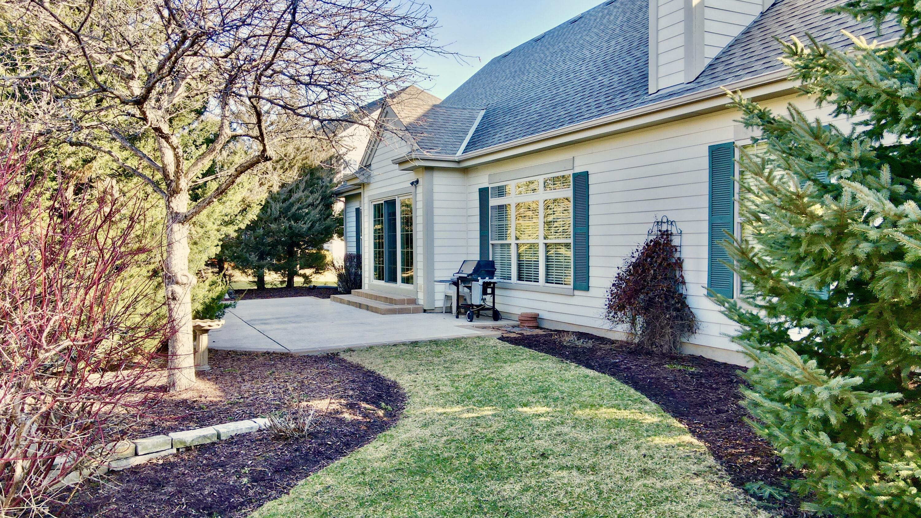 1864 River Lakes Road South Oconomowoc, WI 53066 - Photo 31 of 44 Beautifully Landscaped Backyard
