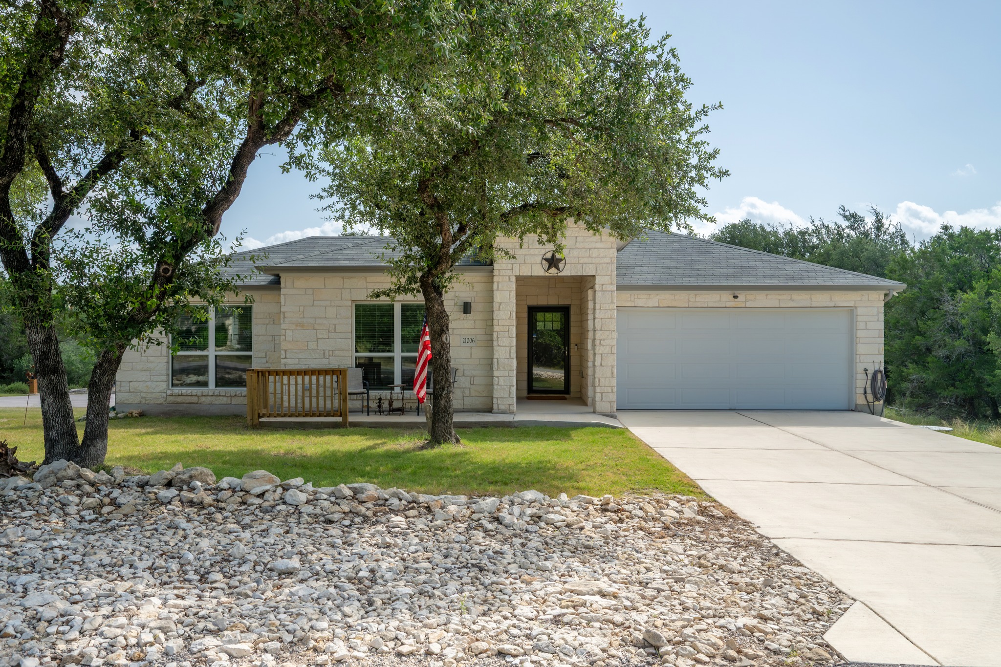 21006 Santa Rosa Avenue Lago Vista, TX 78645 - Photo 23 of 26 A classic stone facade with a spacious concrete driveway offers inviting curb appeal.