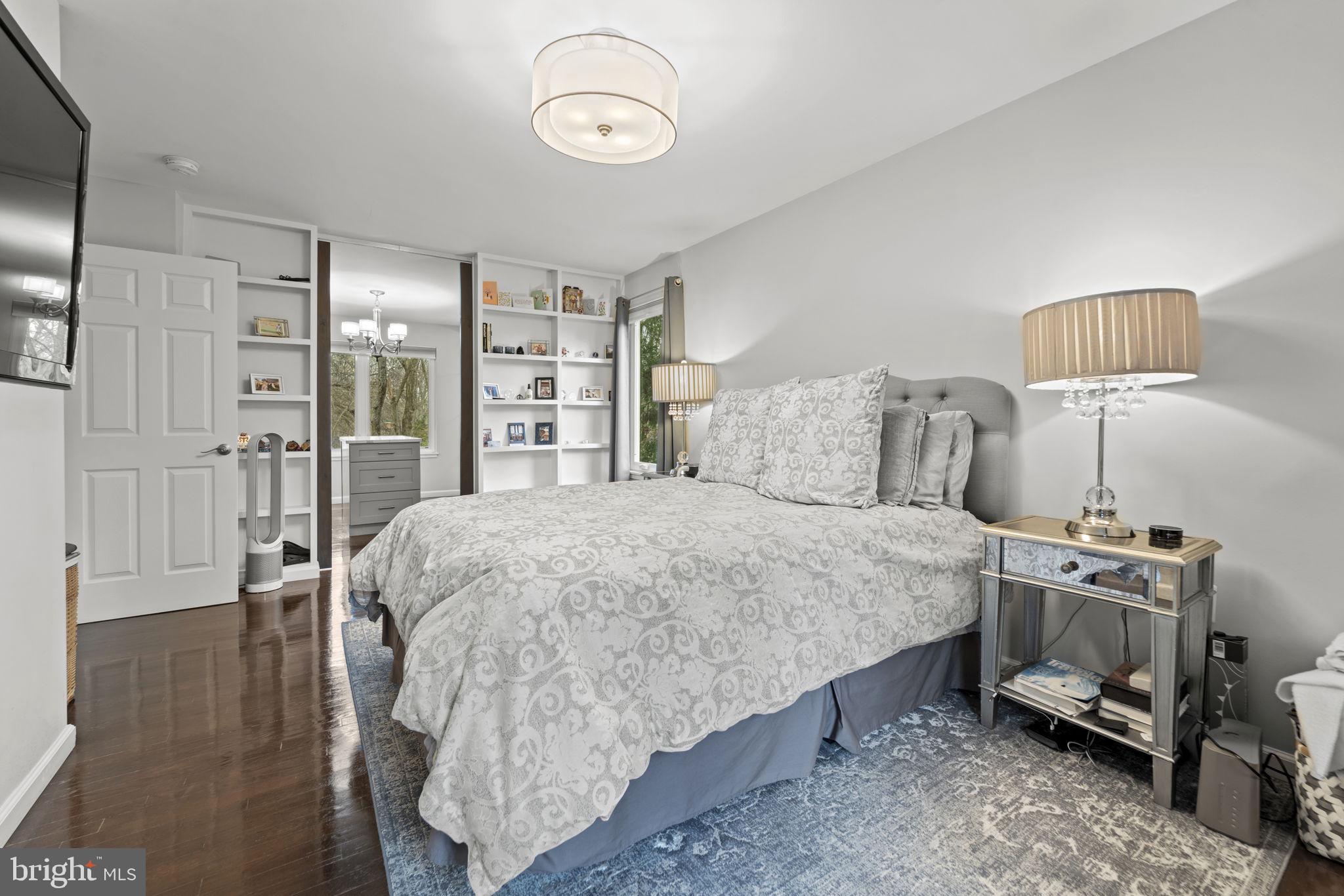 1411 Aldenham Lane Reston, VA 20190 - Photo 12 of 23 a bed sitting in a bedroom next to a lamp