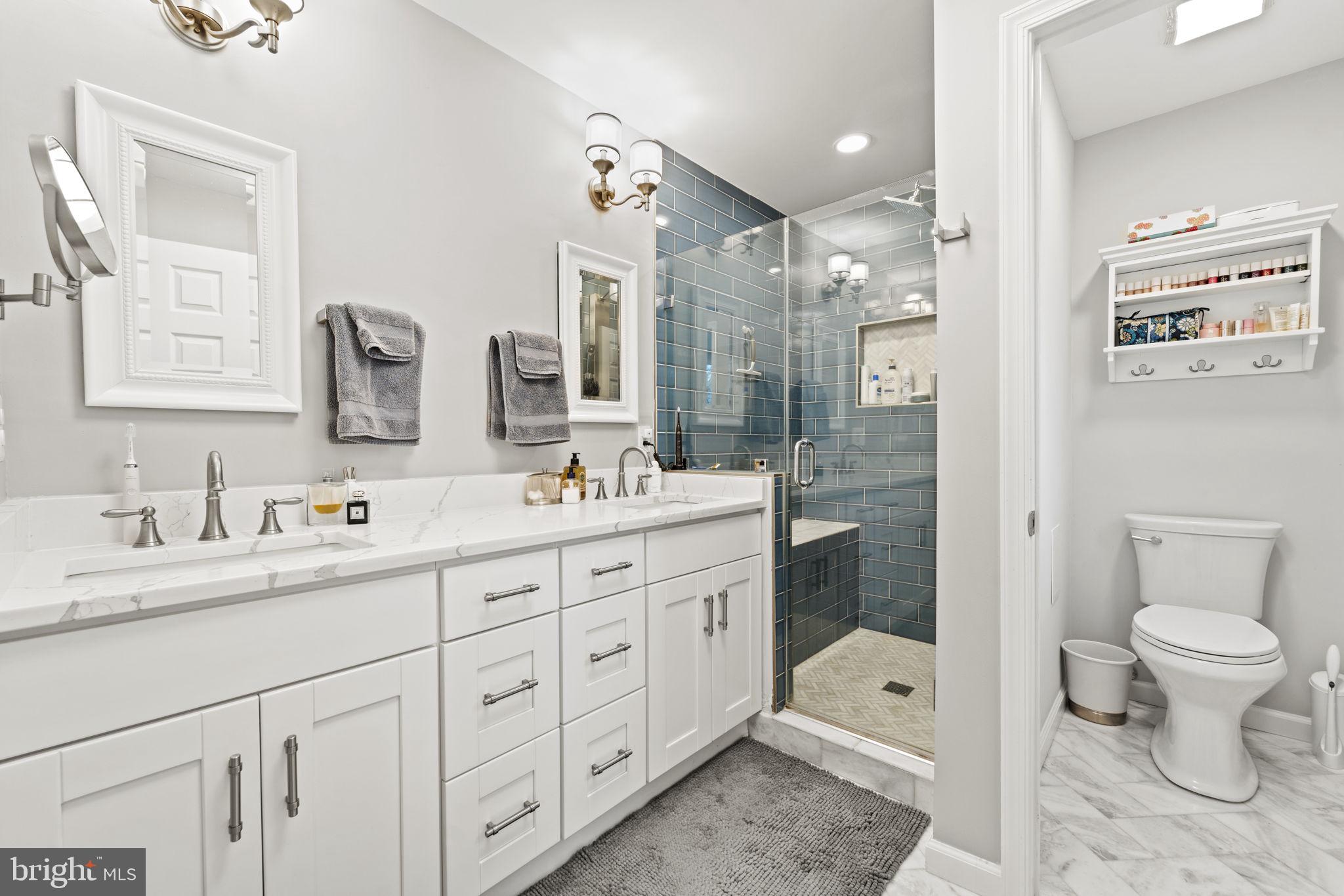 1411 Aldenham Lane Reston, VA 20190 - Photo 14 of 23 a bathroom with a double vanity sink toilet and shower