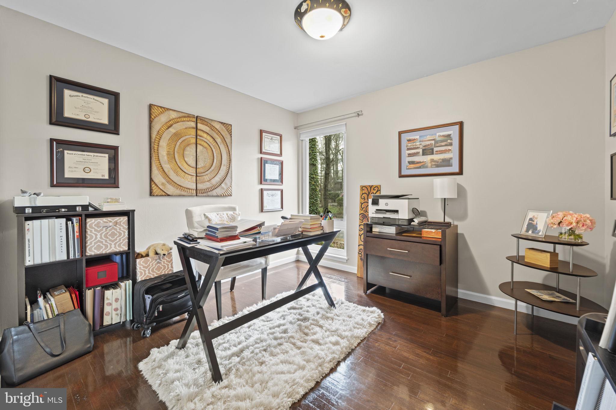 1411 Aldenham Lane Reston, VA 20190 - Photo 15 of 23 a living room with furniture and paintings on the wall with wooden floor
