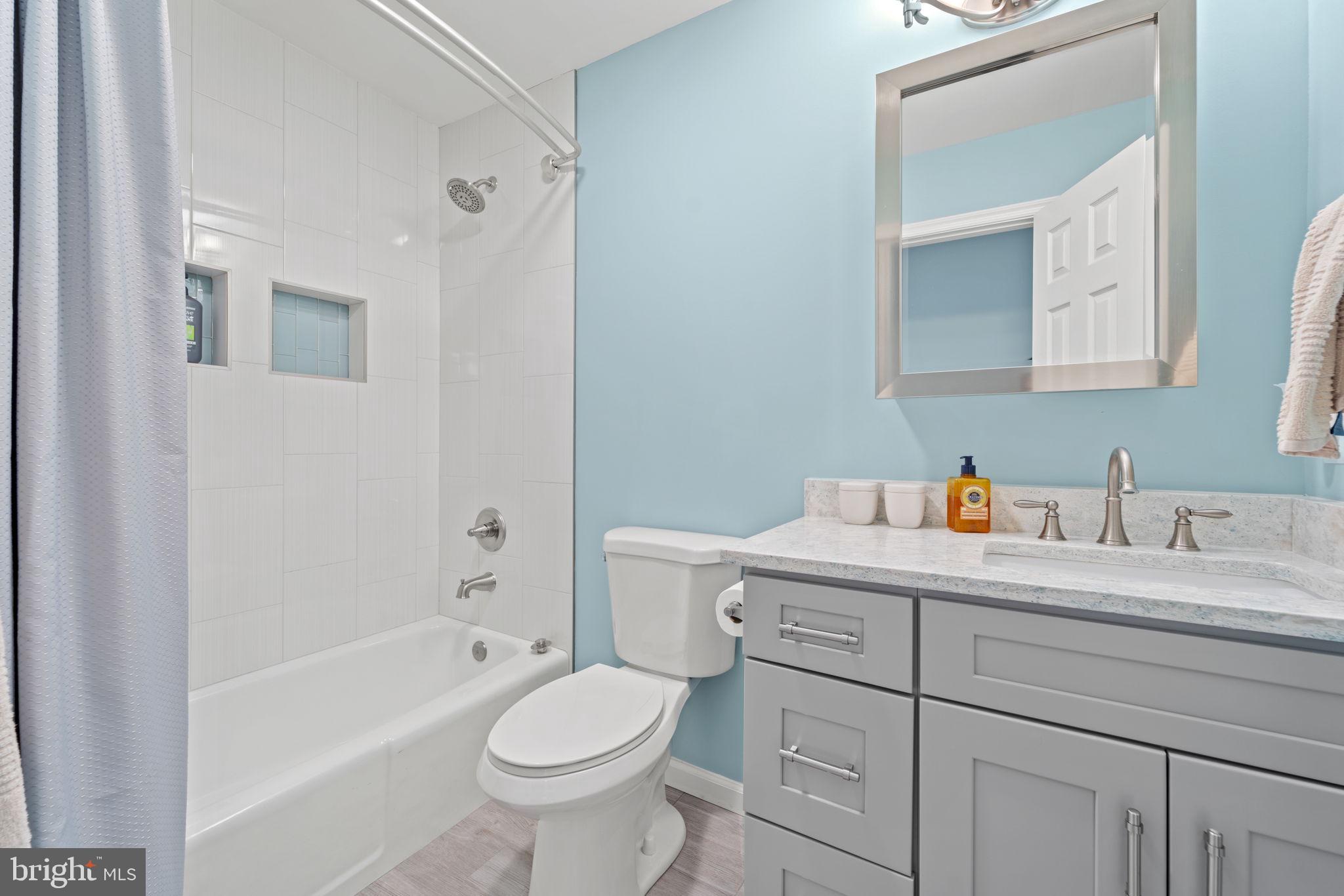 1411 Aldenham Lane Reston, VA 20190 - Photo 16 of 23 a bathroom with a sink a toilet and shower