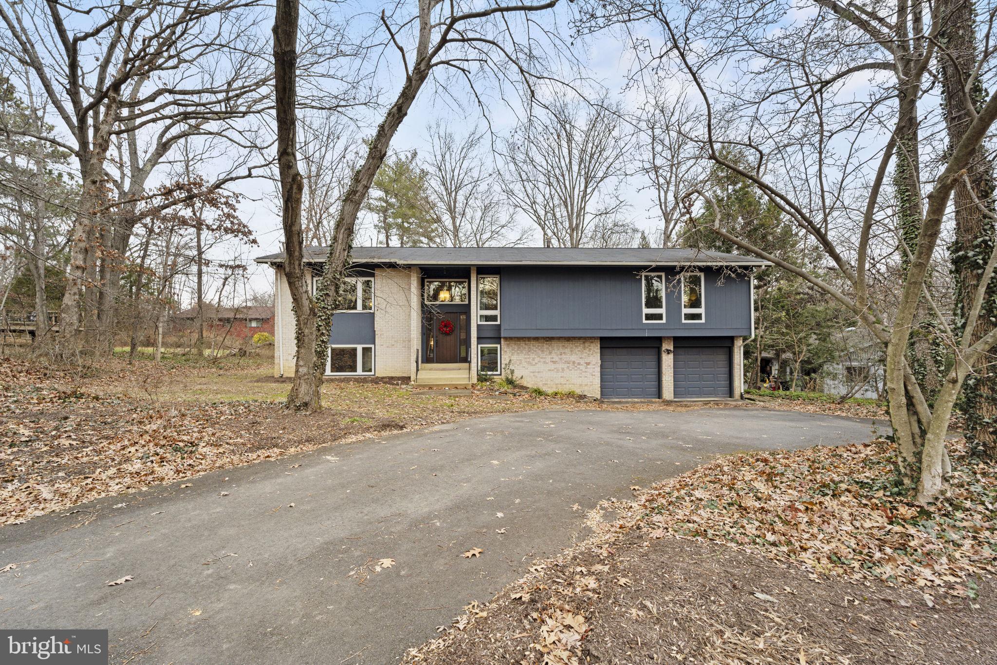 1411 Aldenham Lane Reston, VA 20190 - Photo 2 of 23 a front view of a house with a yard and garage
