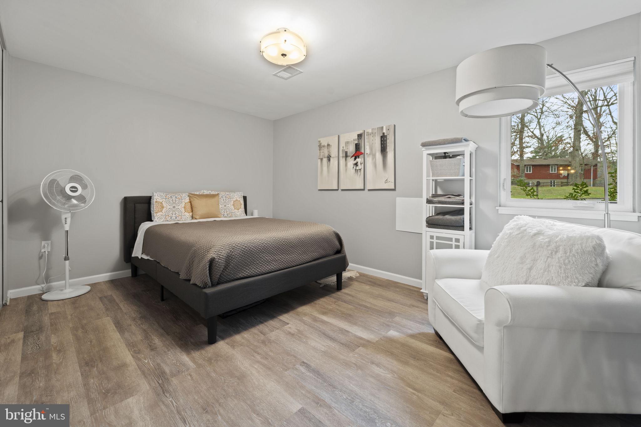 1411 Aldenham Lane Reston, VA 20190 - Photo 21 of 23 a bedroom with a bed and a large window