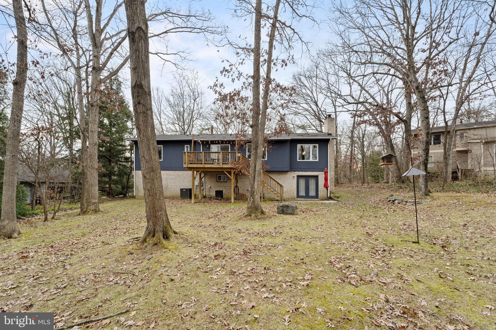 1411 Aldenham Lane Reston, VA 20190 - Photo 22 of 23 a house with trees in front of it