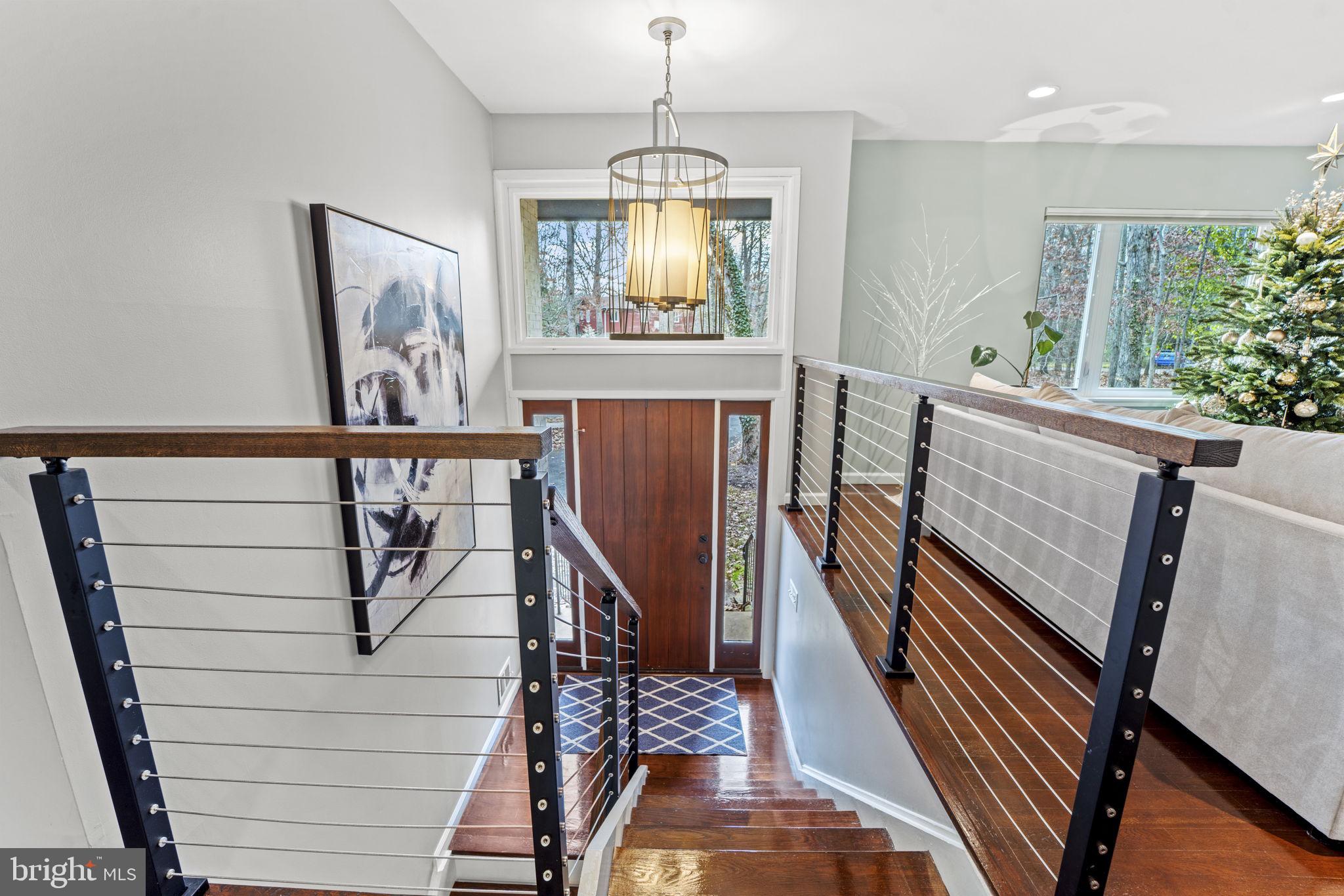1411 Aldenham Lane Reston, VA 20190 - Photo 3 of 23 a view of a livingroom with furniture wooden floor windows and a chandelier