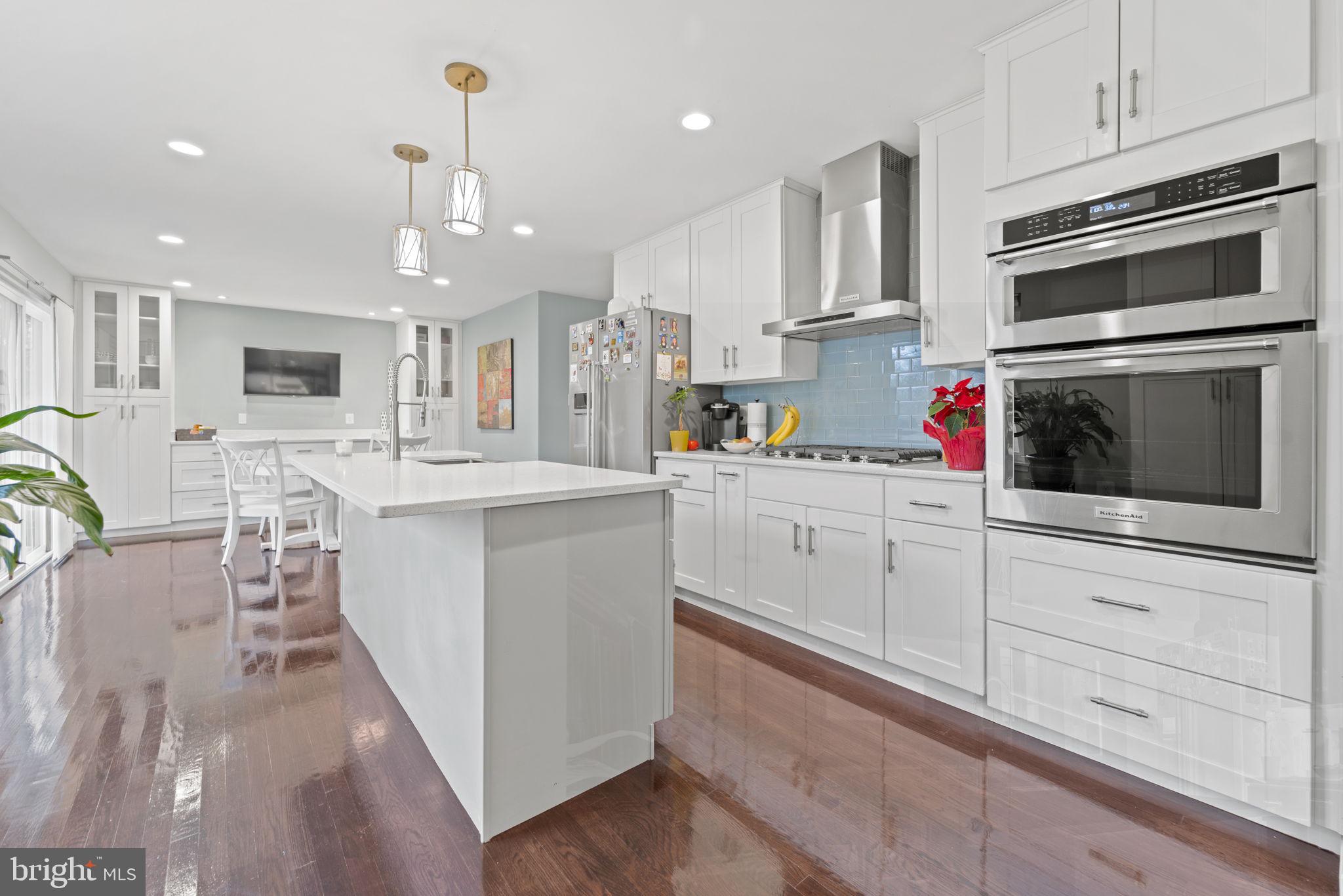 1411 Aldenham Lane Reston, VA 20190 - Photo 6 of 23 a kitchen with stainless steel appliances kitchen island granite countertop a stove a sink and a refrigerator