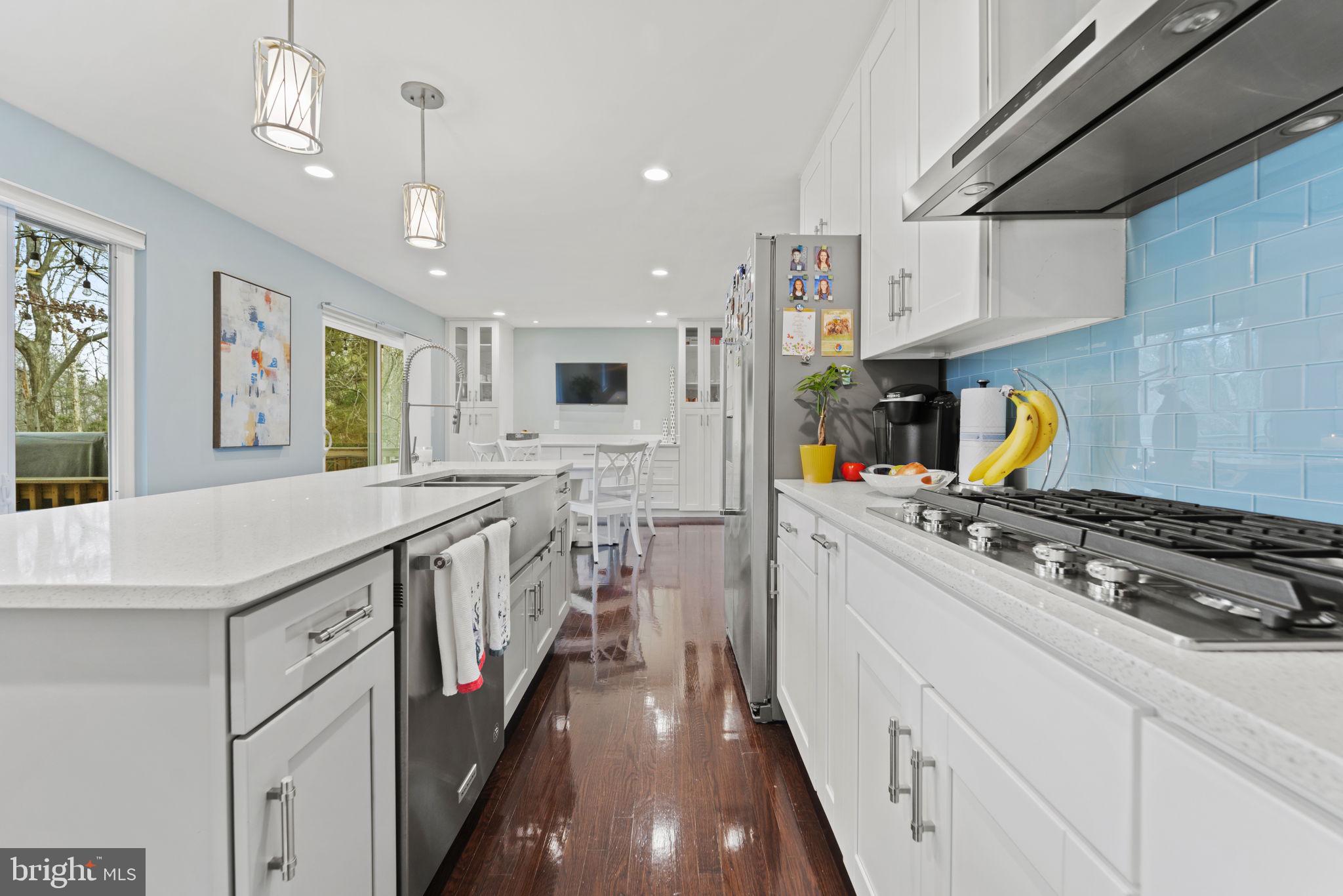 1411 Aldenham Lane Reston, VA 20190 - Photo 7 of 23 a kitchen with stainless steel appliances granite countertop a lot of counter space and wooden floors