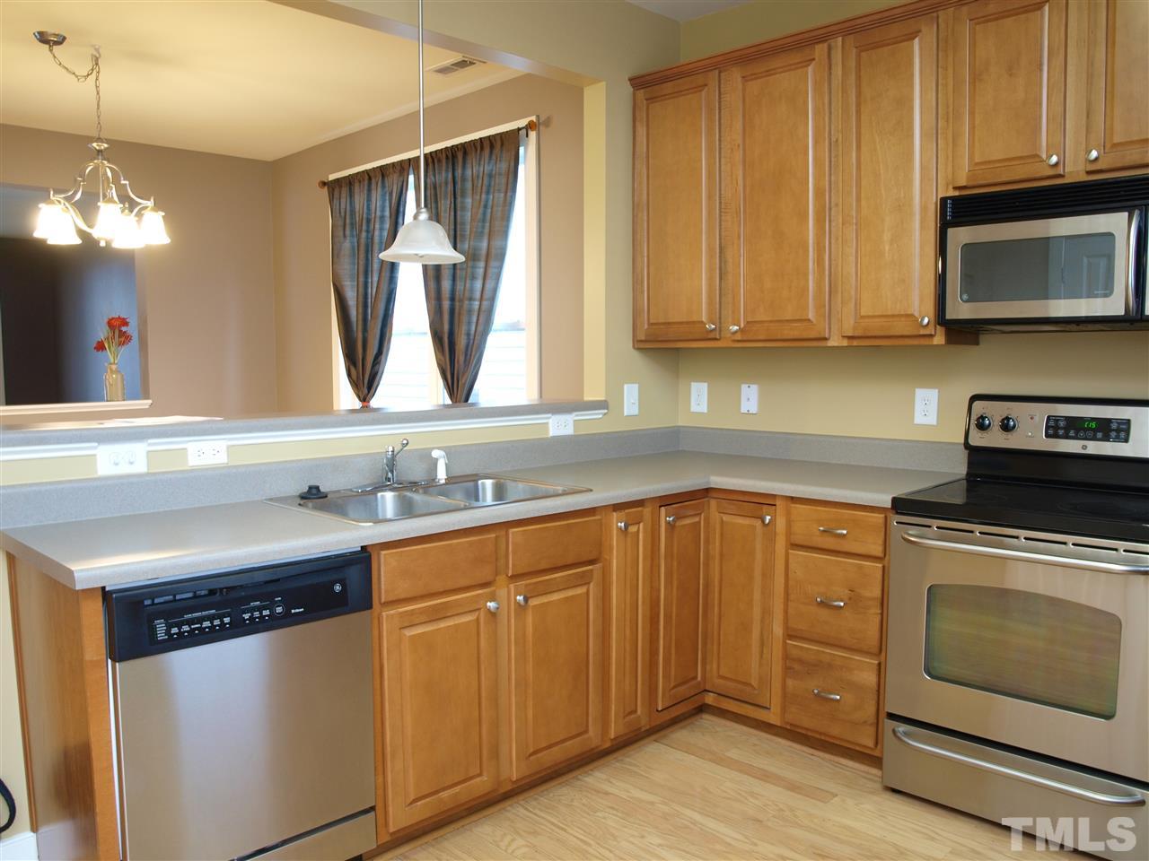 4531 All Points View Way Raleigh, NC 27614 - Photo 2 of 23 a kitchen with stainless steel appliances a stove a sink and a microwave