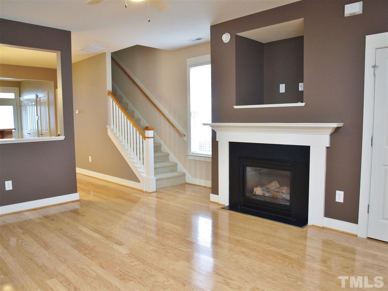 4531 All Points View Way Raleigh, NC 27614 - Photo 4 of 23 a view of an empty room with wooden floor and a fireplace