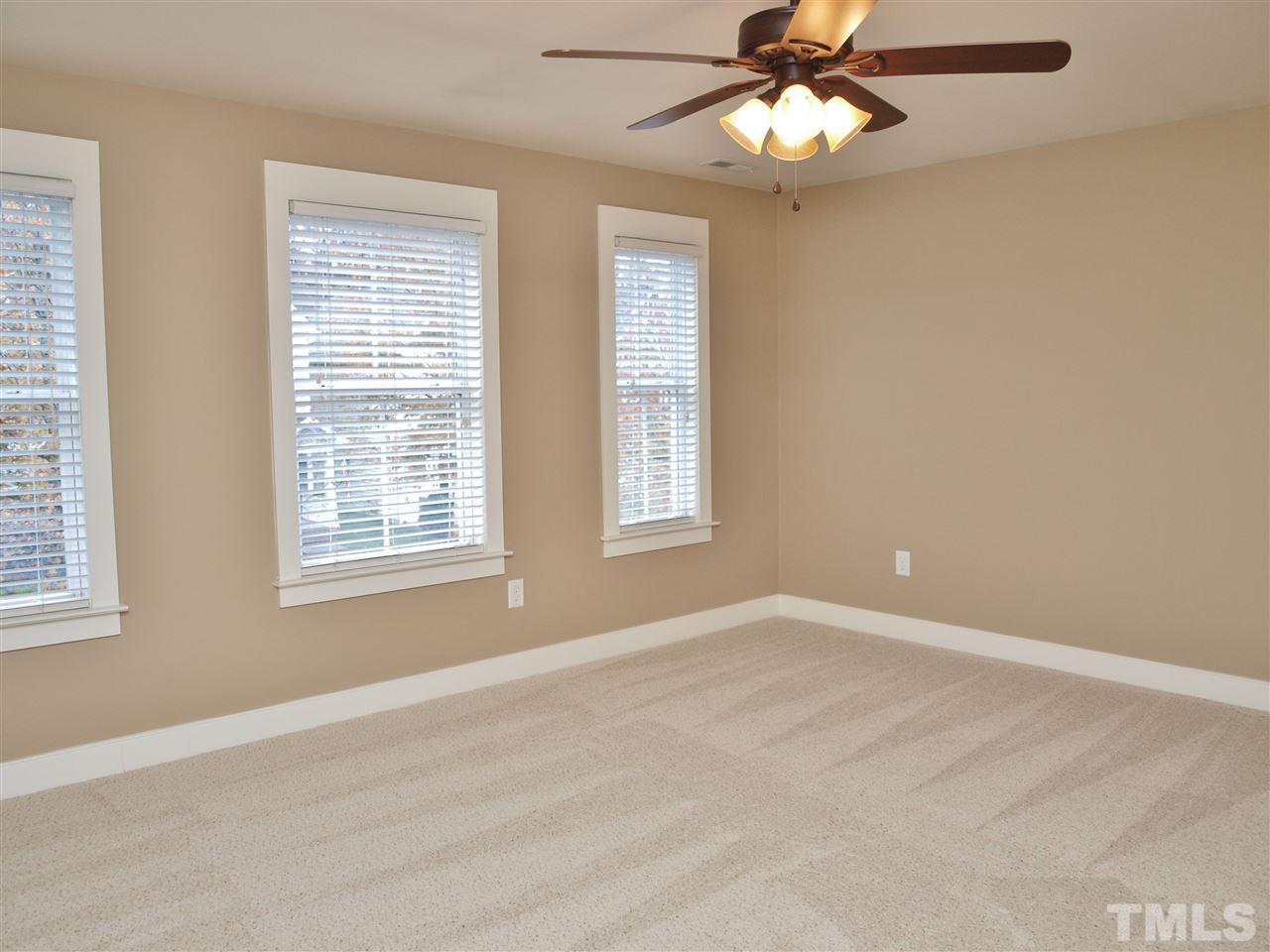 4531 All Points View Way Raleigh, NC 27614 - Photo 6 of 23 an empty room with window and chandelier fan