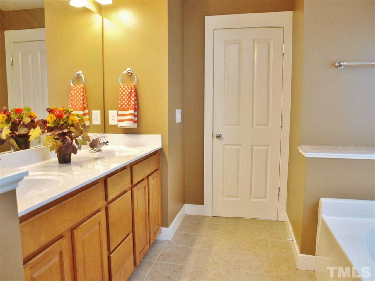 4531 All Points View Way Raleigh, NC 27614 - Photo 7 of 23 a bathroom with a double vanity sink a mirror and a shower