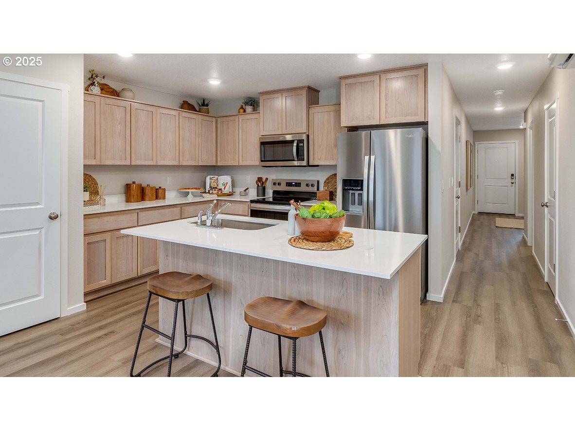 6161 Southeast 15th Street Gresham, OR 97080 - Photo 6 of 34 a kitchen with a table chairs refrigerator and cabinets