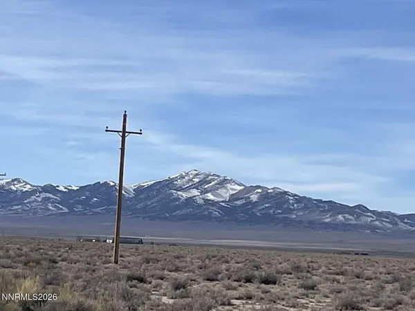 a view of a mountain with a field