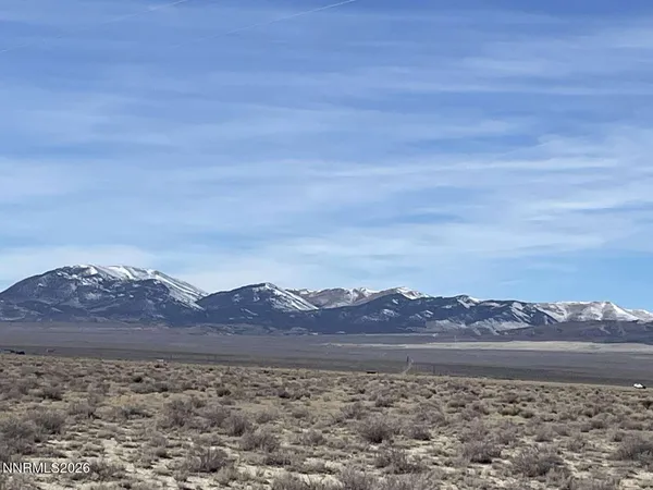 a view of mountain with sunset in background