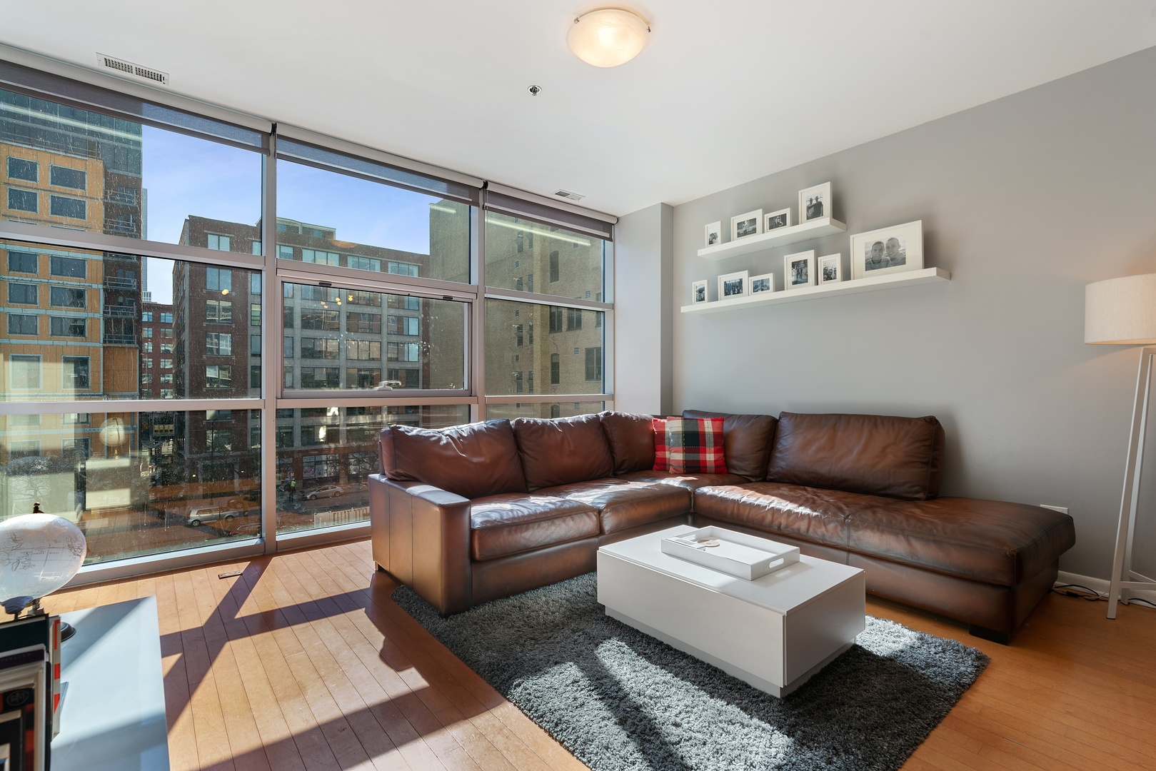 225 South Sangamon Street, Unit 402 Chicago, IL 60607 - Photo 2 of 12 a living room with furniture and a floor to ceiling window