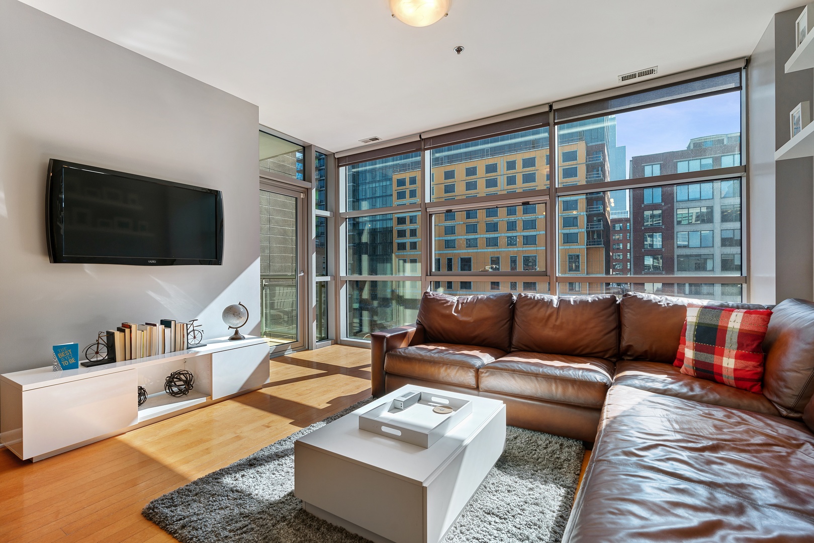 225 South Sangamon Street, Unit 402 Chicago, IL 60607 - Photo 3 of 12 a living room with furniture and a flat screen tv