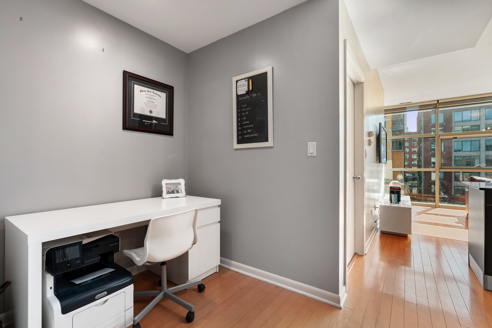 225 South Sangamon Street, Unit 402 Chicago, IL 60607 - Photo 7 of 12 a view of a workspace with furniture and wooden floor