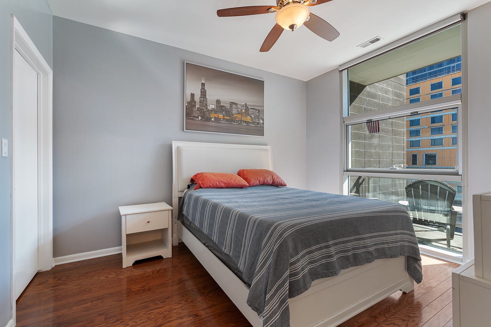 225 South Sangamon Street, Unit 402 Chicago, IL 60607 - Photo 8 of 12 a bedroom with a bed and a chandelier