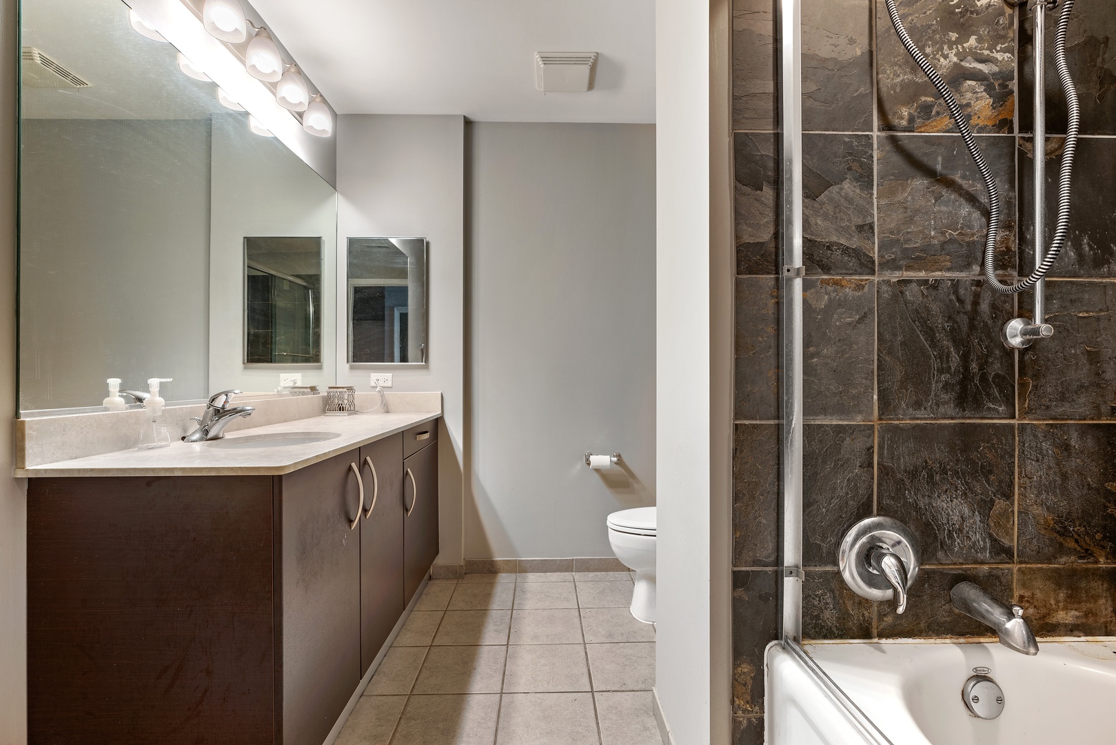 225 South Sangamon Street, Unit 402 Chicago, IL 60607 - Photo 9 of 12 a bathroom with a sink a toilet and shower