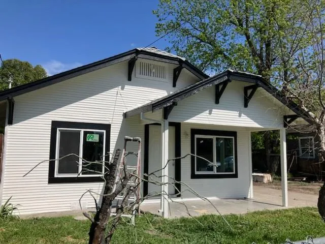 a front view of a house with garden