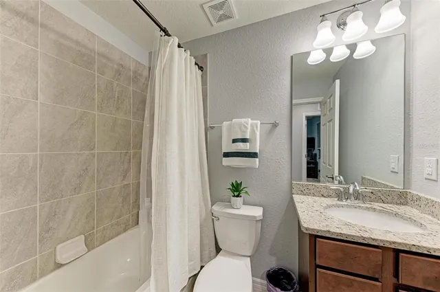 a living room with furniture fireplace and a table