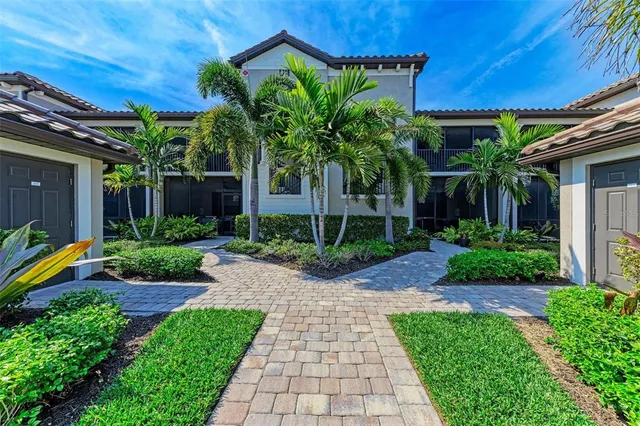 a large kitchen with kitchen island a sink a counter top space and stainless steel appliances