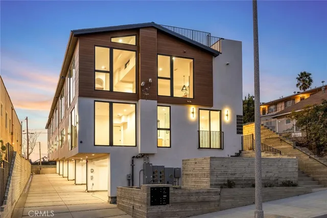 a front view of a residential apartment building with a yard