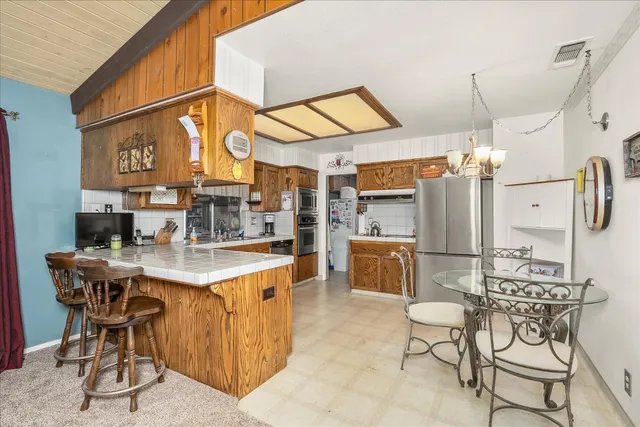 a kitchen with stainless steel appliances a sink and a refrigerator