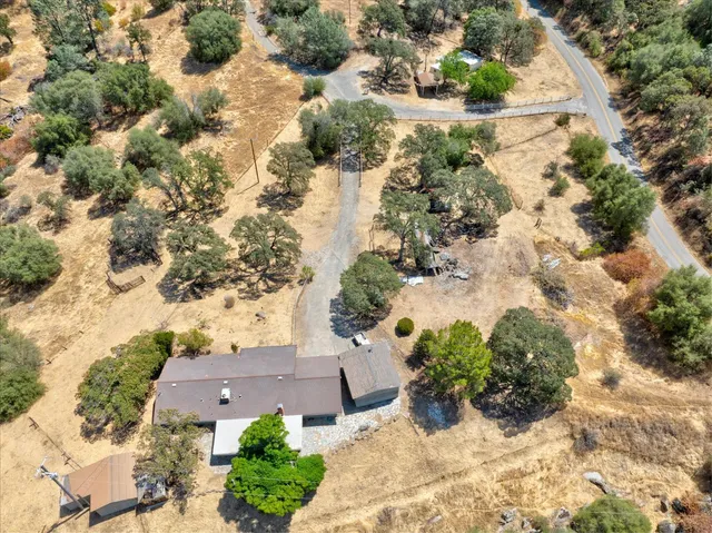 an aerial view of a house with a yard