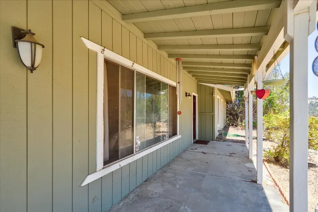 a view of a porch with wooden floor and stairs